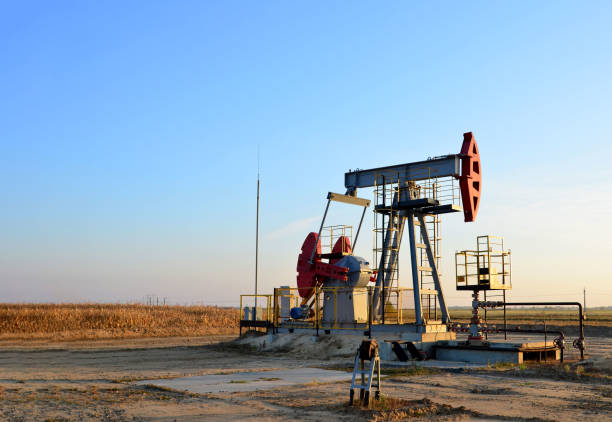 istock Pumpjack (Oil Rig) In The Sunset. Oil drill rig and pump jack 1202577724