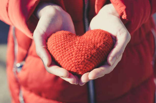 istock Girl holds a red heart. Valentine's Day Gift 1202579363