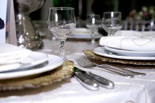 istock Table setting with glasses, plates, napkins and food 1202580154