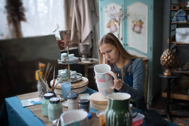 istock Young woman in her pottery workshop, small business concept 1202580403