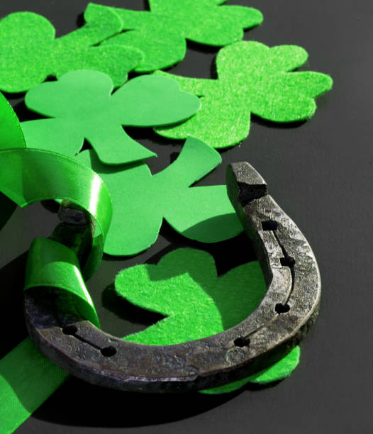 istock Clover and horseshoe on a dark background. St. Patrick's Day. 1202580692