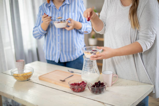 istock Female hands making healthy breakfast. 1202580899