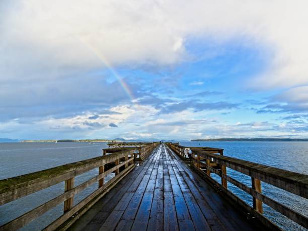 Rainbow  over fishing pier in Sidney BC, stock photo