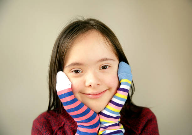 istock Beautiful girl smiling with different socks 1202584985