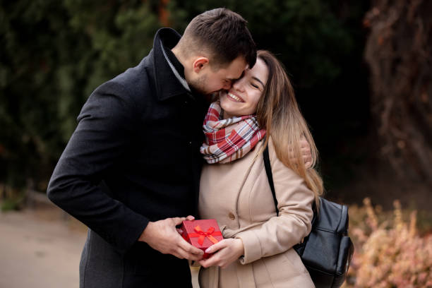 istock guy gives a girl box with a gift 1202585100