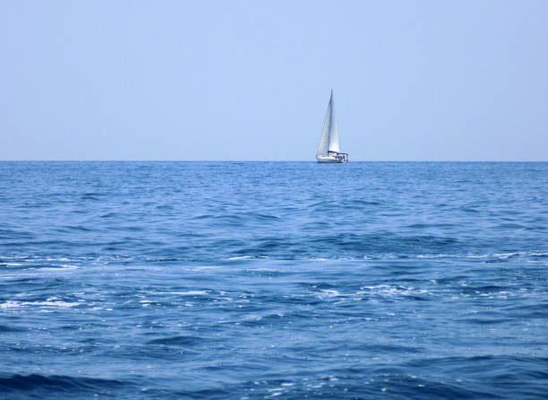 istock Sailboat is sailing towards the horizon 1202585365