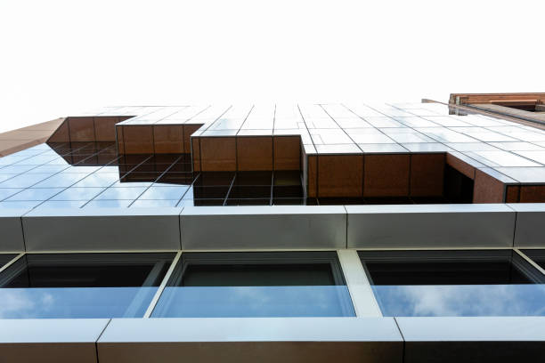 Low angle view of modern glass office building, skyscrapers, white background with copy space, full frame horizontal composition