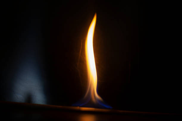 Close-up of candle flame against black background.