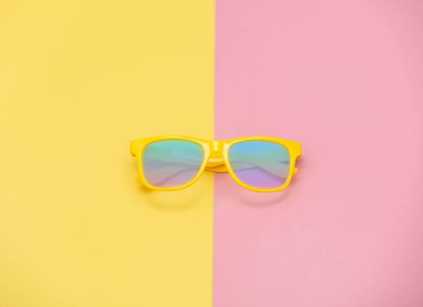 istock Style sunglasses on pink and yellow backgrounds. 1202593481