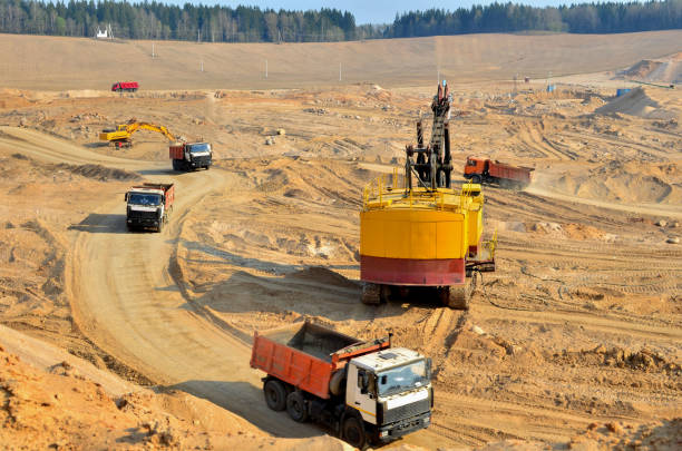 istock Excavator loading sand to the heavy dump trucks at opencast 1202594915