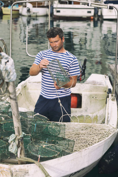 istock Fisherman preparing net for next day fishing 1202596855