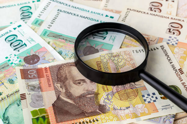 Magnifier on bulgarian lev banknotes. Check the authenticity of money. Wealth, poverty and counterfeiting money concept. stock photo