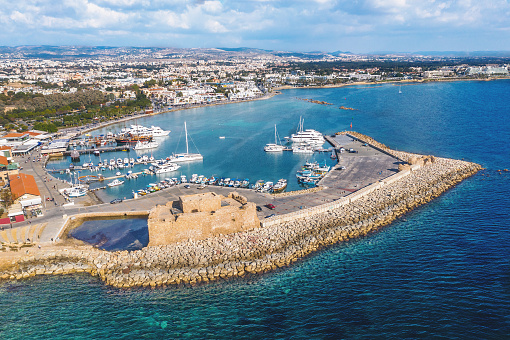 Famous Paphos Castle in harbour on embankment or promenade of city Paphos in Cyprus, aerial drone view.