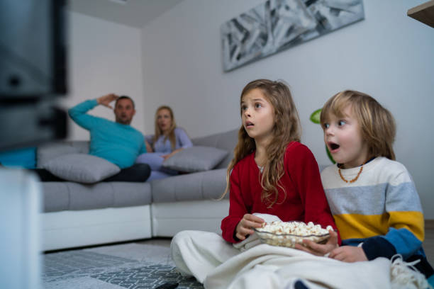 istock Family watching television 1202609350