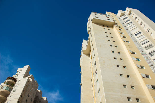 istock ordinary living building modern architecture concrete exterior facade construction foreshortening from below on vivid blue sky background urban landmark city view 1202611207