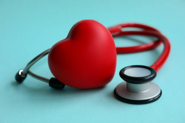 istock Red stethoscope with heart on blue modern background 1202612451