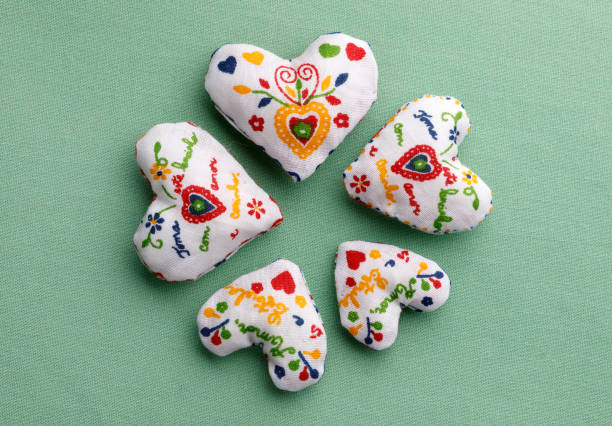 Lot of heart cushions on geen background