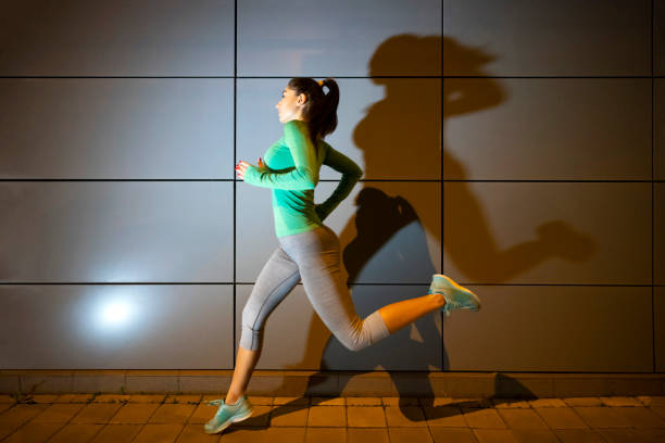 istock Up late for her night jog 1202620133