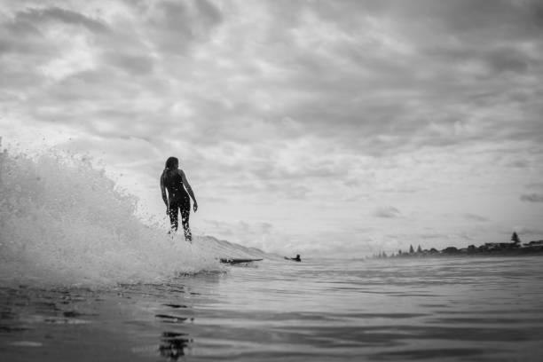 istock A surfer woman riding the wave 1202622150