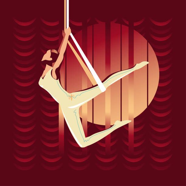 The girl hangs on the trapeze upside down