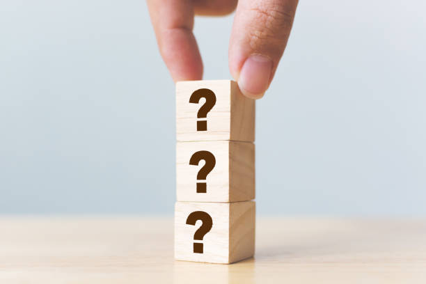istock Wooden cube block shape with sign question mark symbol on wood table 1202622703