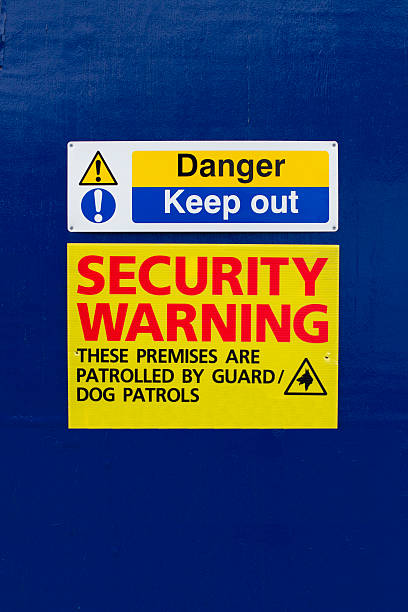keep out security warning sign on blue background stock photo