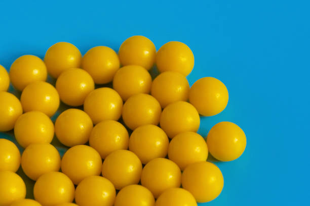 istock Yellow vitamins on a blue background. Vitamin complex against the virus. Multivitamins to enhance health and immunity. Medical concept 1202638108