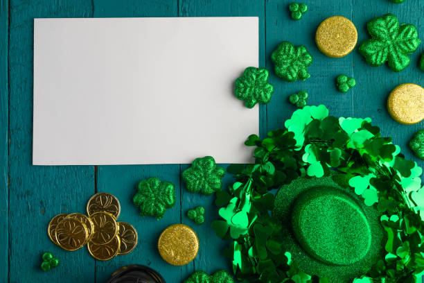 istock White postcard for design St. Patrick's Day celebration, on green wooden background, top view 1202640539