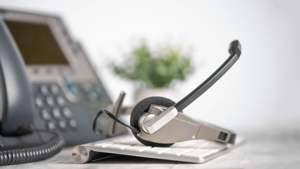 istock VOIP headset headphone phone, background for support service, assistance, call center. Light background 1202647044