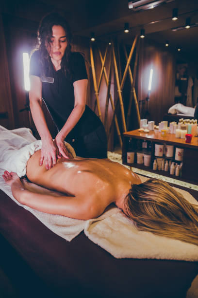 istock Young woman enjoying in back massage 1202647838