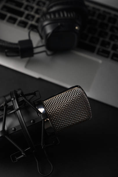 istock Blogging, podcasts, streams and broadcast, background. Black studio microphone on a laptop on a black background 1202650277