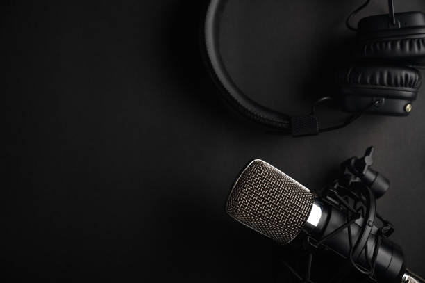 istock Podcasts and Stream. Flat lay. Studio condenser microphone black with professional headphones, top view with space for design. 1202651735