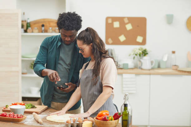 istock Couple cooking with mobile app 1202661573