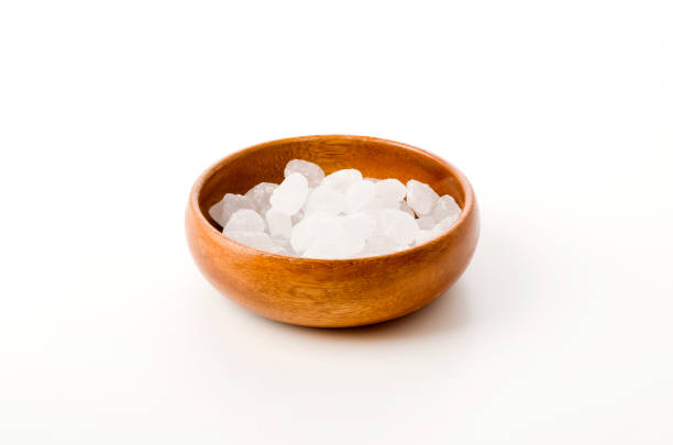 istock white rock sugar in a Round Wooden bowl on white background 1202663893