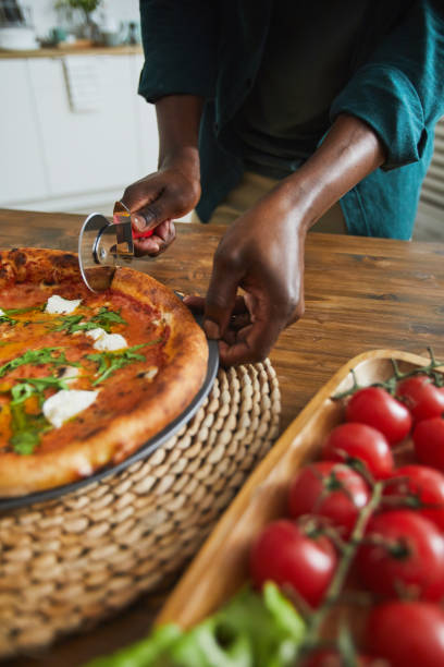 istock Man eating pizza at home 1202664176