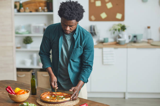 istock Man eating homemade pizza 1202664848