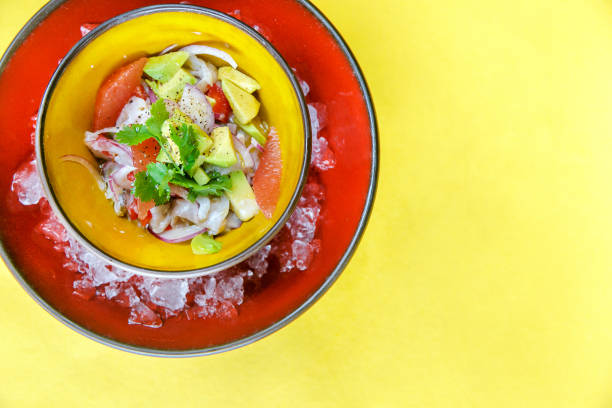 Peruvian appetizer ceviche de lubina y camaron on the ice Peruvian appetizer on the ice shrimps and scallop with onion and avocado and garnish tartuffo stock pictures, royalty-free photos & images