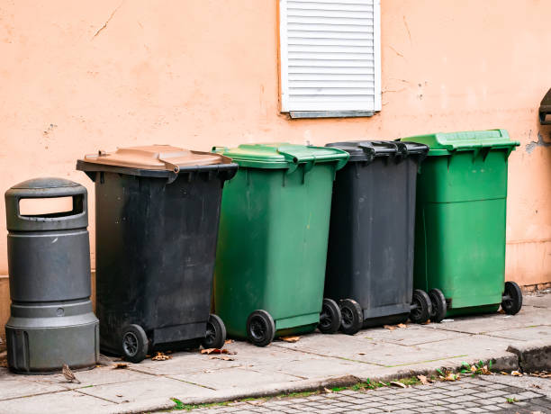 istock several garbage cans stand near the wall 1202669812