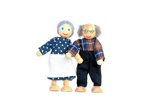 Dolls An elderly man and woman. Grandfather and grandmother hold the hand, a symbol of love and trust. Valentine's Day, love. On white background.
