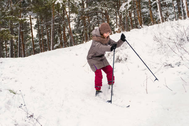 istock smile girl skiing downhill on a white snow 1202673240