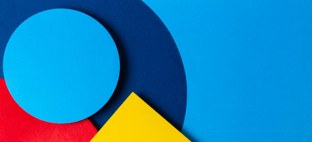 istock Abstract colored paper texture background. Minimal geometric shapes and lines in light blue, navy, red and yellow colors 1202673317