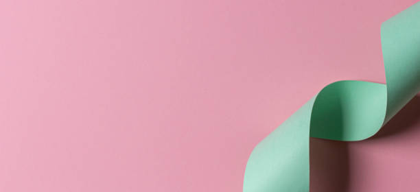 istock Abstract geometric shape light green and pink color paper background 1202673585