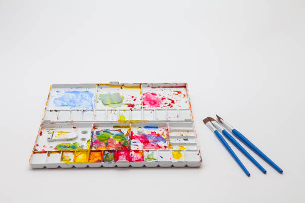 istock Paint brushes and Watercolor pallet isolated on white 1202675084