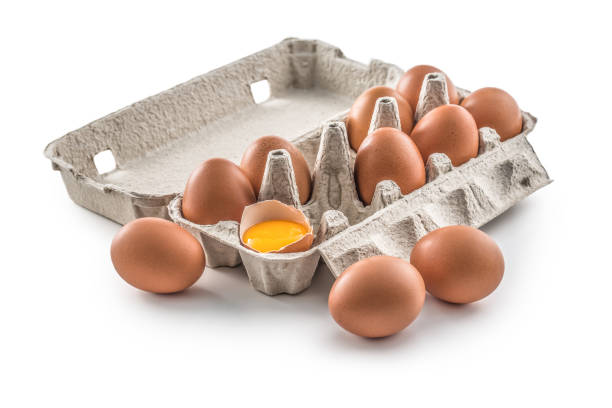 istock Fresh chicken eggs in pater tray with broken egg isolated on white 1202675166