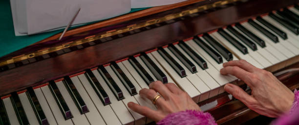 istock Unidentifiable pianist playing a grand piano 1202676404