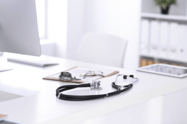 istock Stethoscope, prescription medical form lying on a table with pc computer. Medicine or pharmacy concept. Medical tools at doctor working table 1202677899