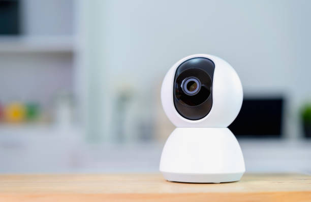 istock White CCTV Camera on the table in the house, Concept Security technology. 1202679000