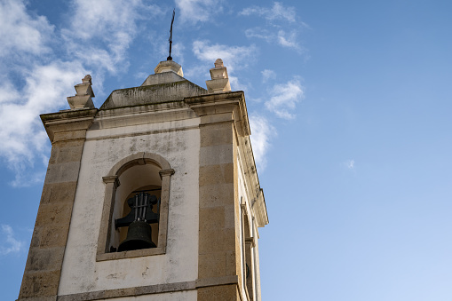 Historical bell tower of Igreja de Matriz in the old town village area of Albufeira in Portugal