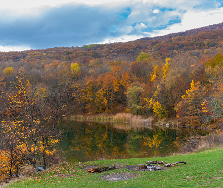 Autumnal colorful landscape with forest lakeside on Crimean mountains