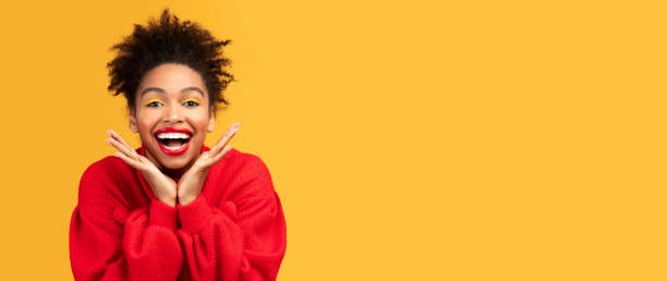 istock Happy black girl screaming and touching cheeks 1202680727
